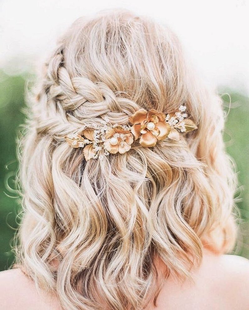 Dutch braided wavy half updo with decorative hair pin