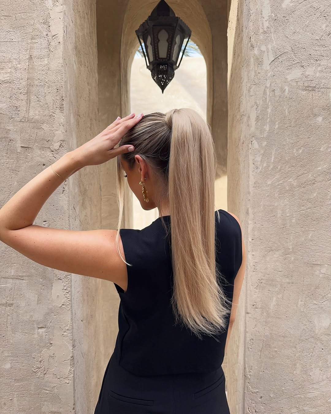 high ponytail with face-framing tendrils