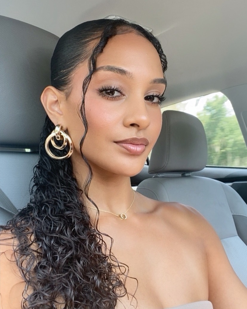 slicked-back half-up half-down with face-framing strands