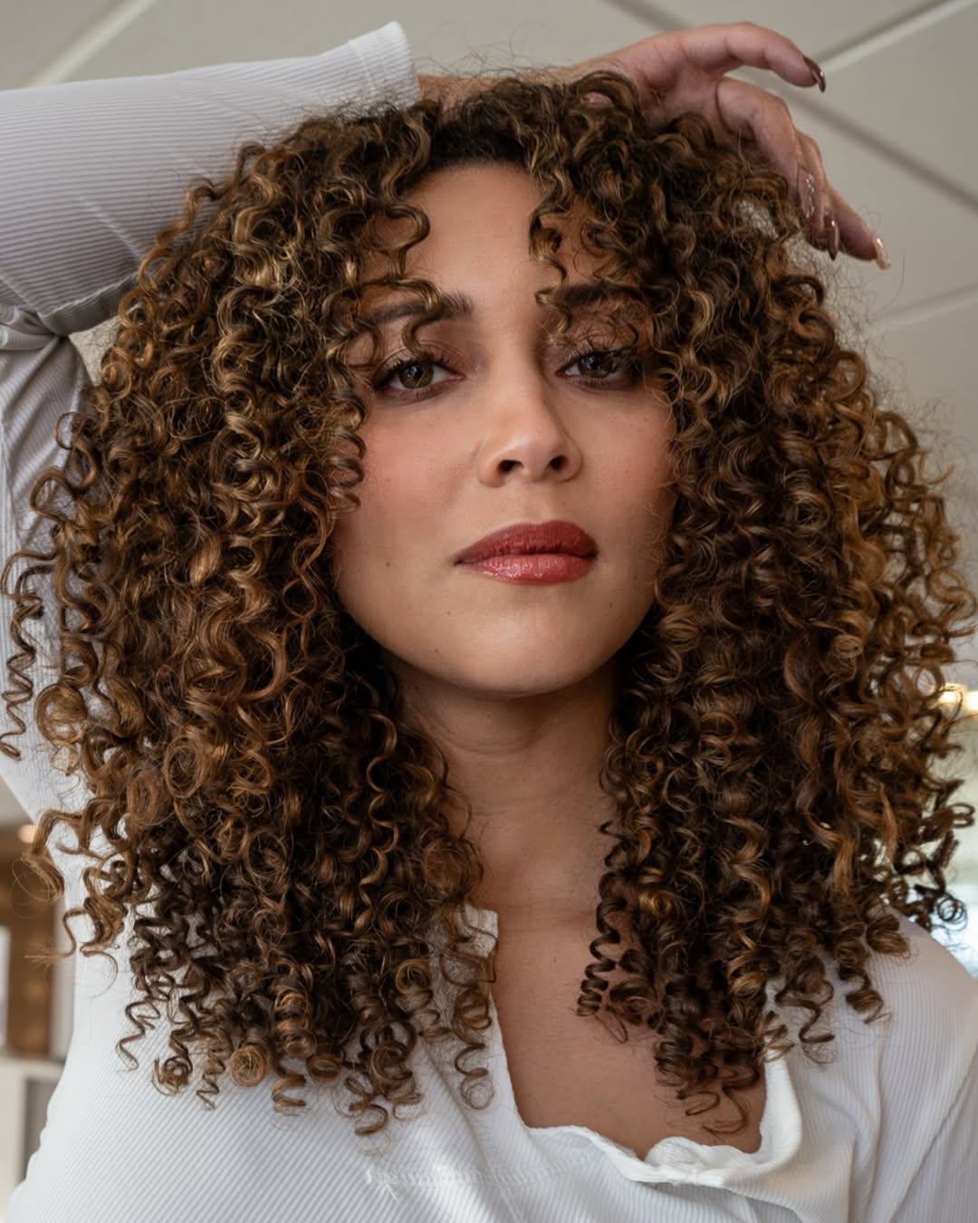 shoulder-length haircut for women with curly hair