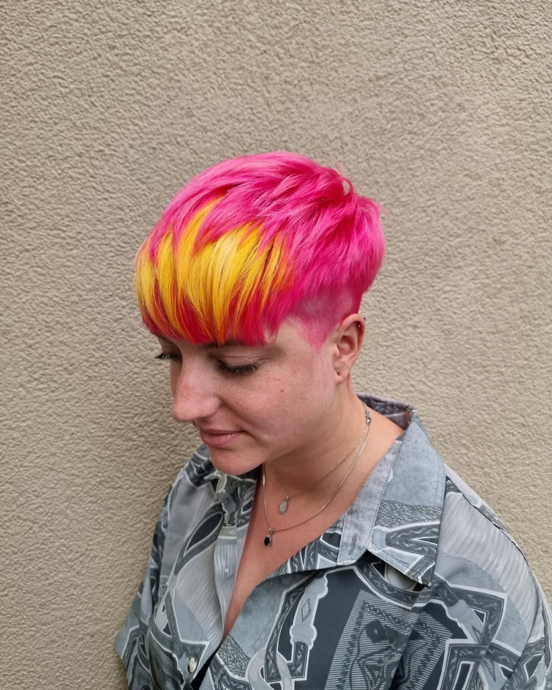 vibrant pink pixie bowl cut