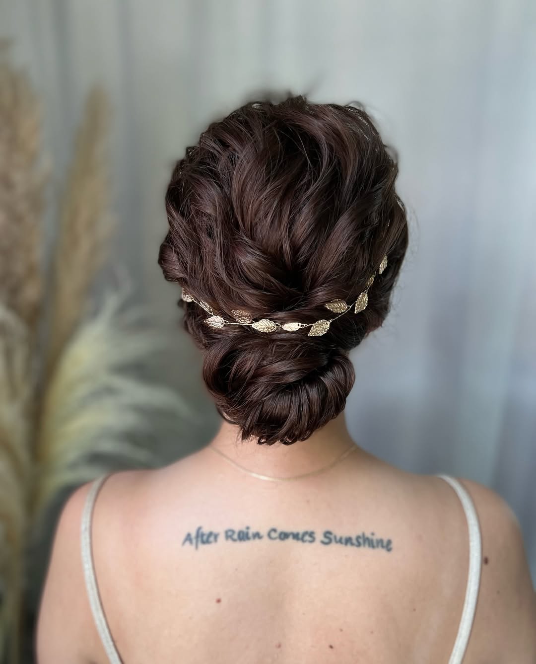 wedding bun updo with a gold leaf crown
